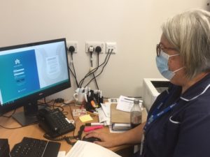 Photo of Sister at computer on new hip and knee app