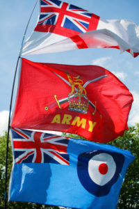 Flags of the British Armed Forces - the Navy's White Ensign, the British Army flag and the Royal Air Force Ensign.